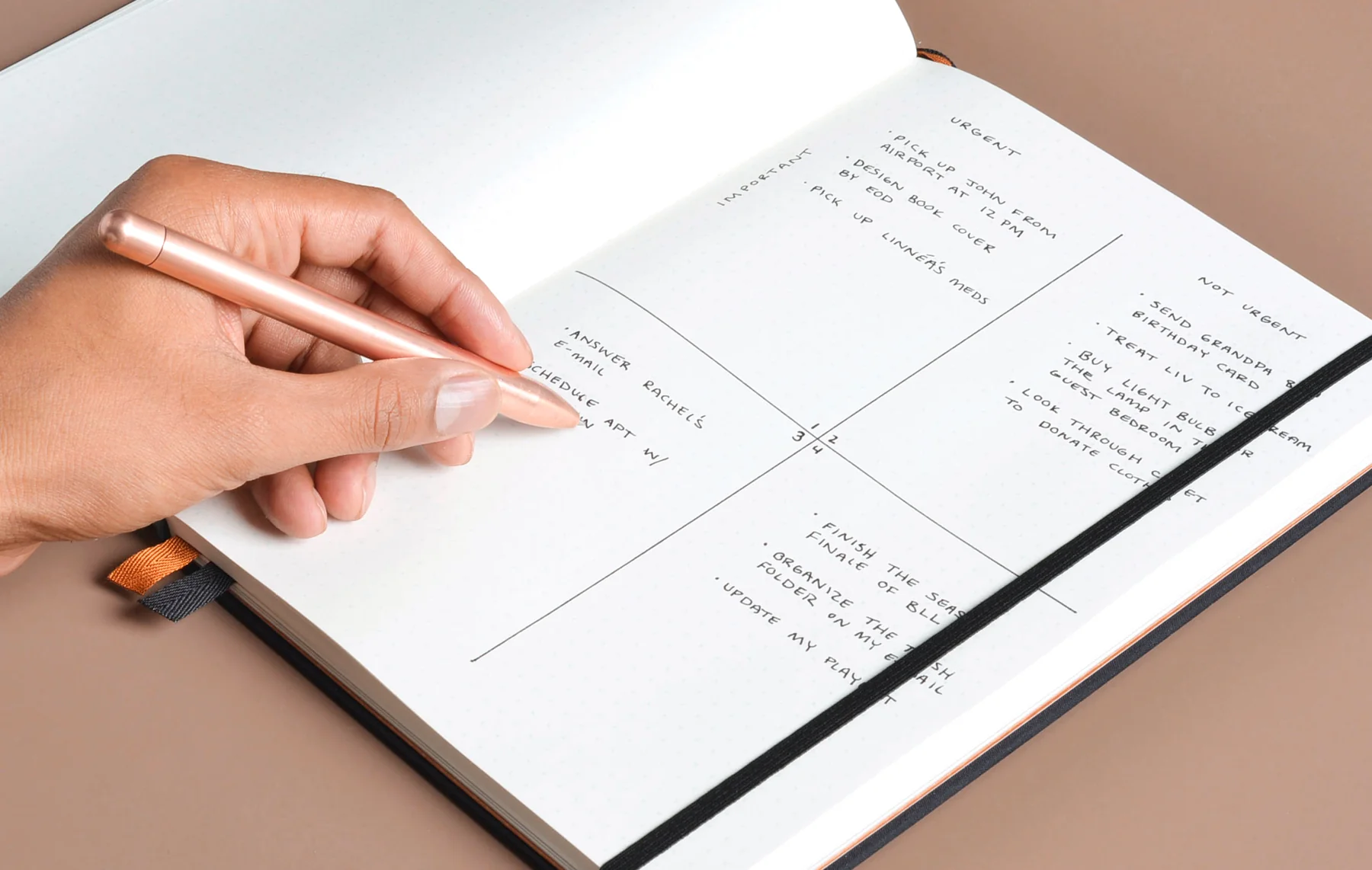Daily habit tracking journal with pen on wooden desk